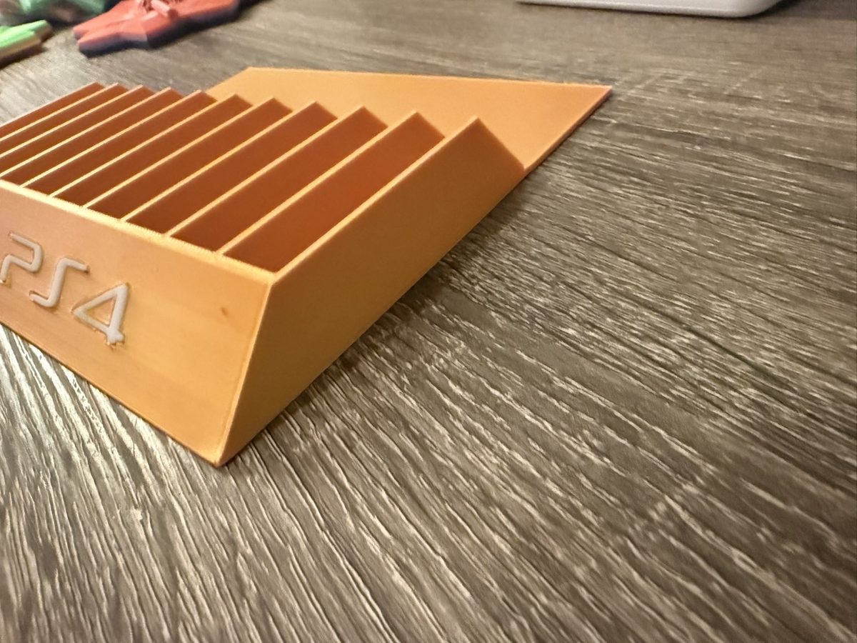 Orange PS4 game holder close-up
